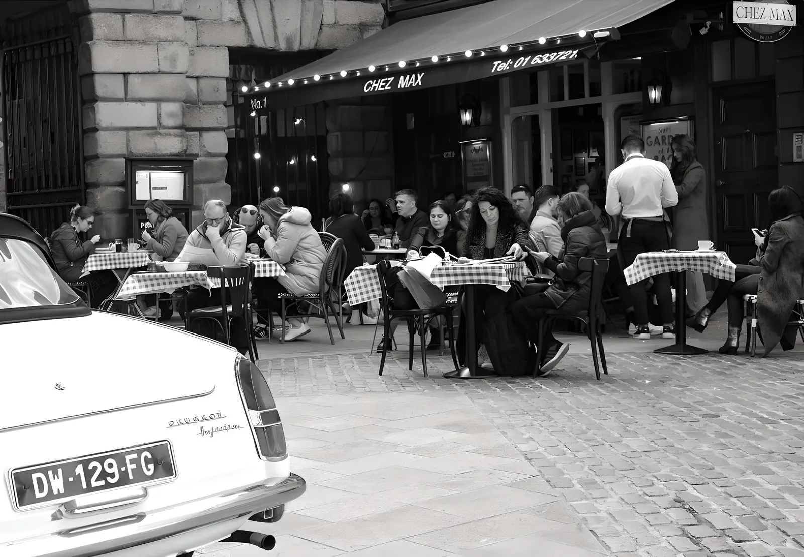 Guests dining on the Chez Max terrace under the awning at 1 Palace Street